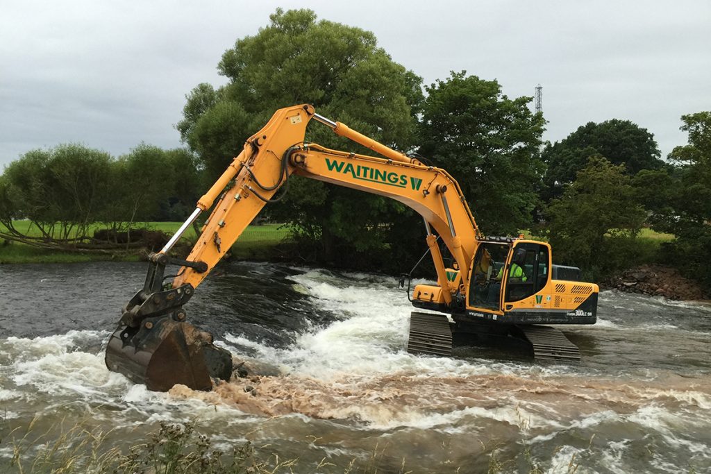 Digger removing a weir in the River Eamont