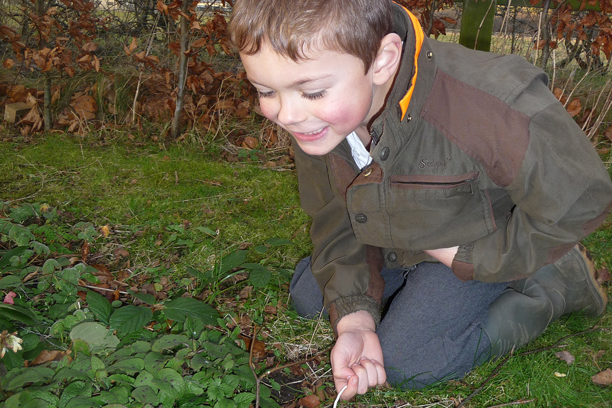 Boy kneeling near the ground