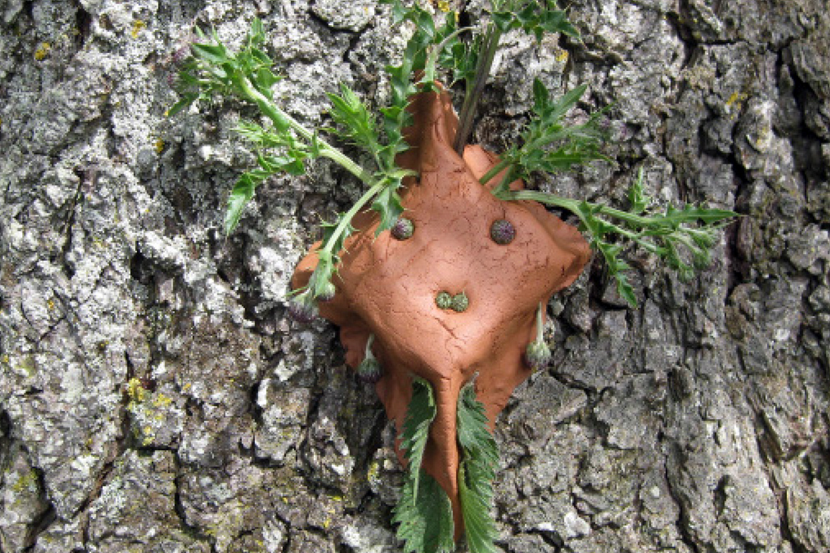 a mud monster stuck to a tree