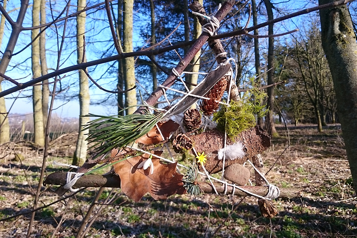 Memory catcher made from natural materials hung from a tree