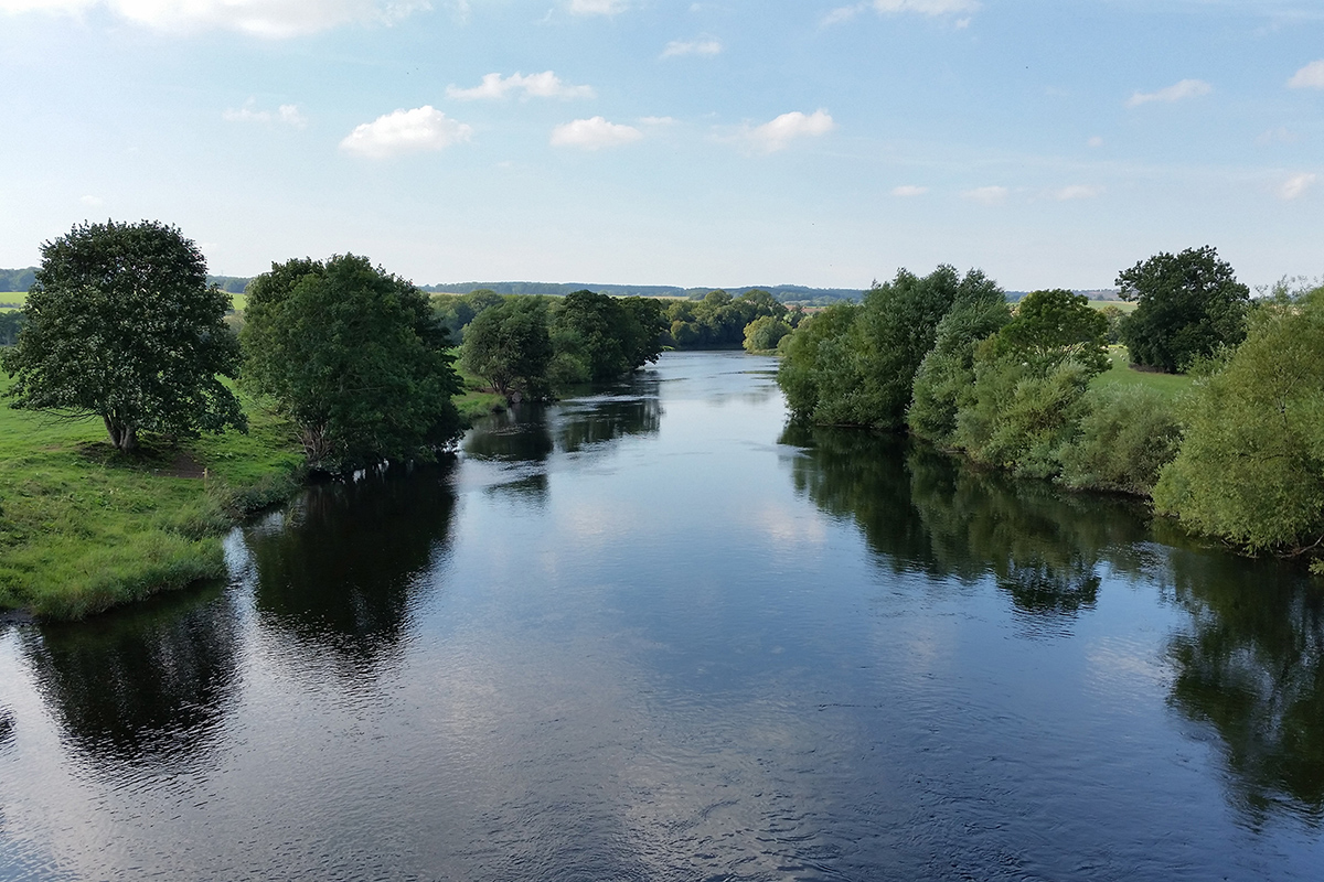 River Eden at Langwathby with trees by the riverbank