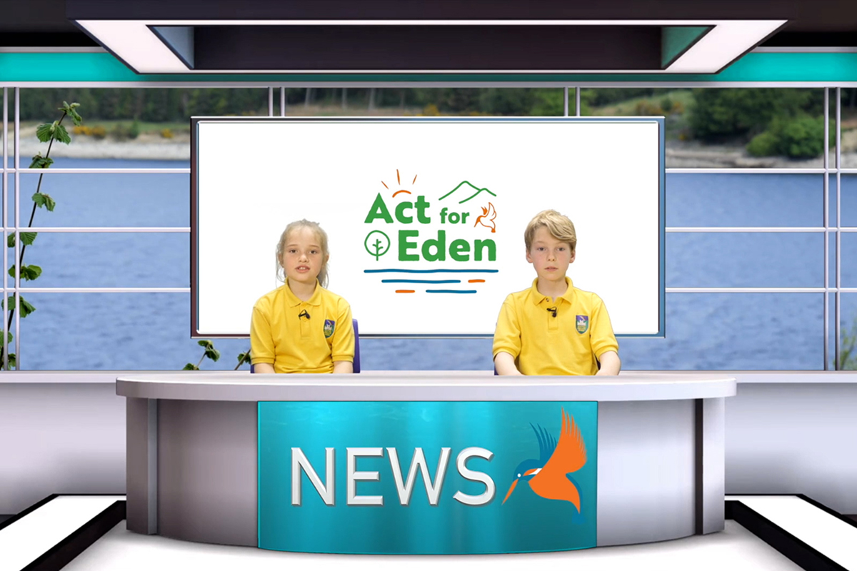 Children sat behind a newsdesk