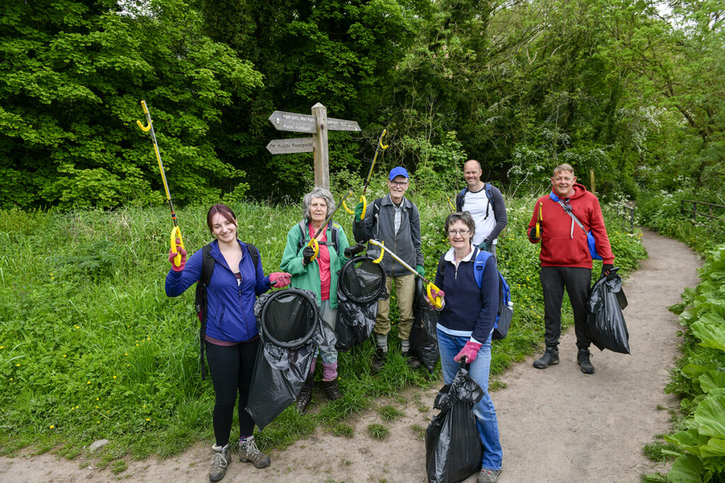 people litter picking along a footpath