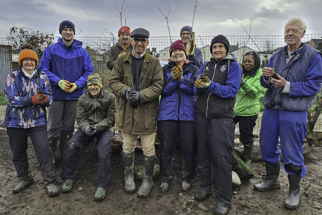 Group of people holding tree twigs